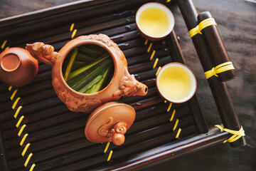 Bamboo Tea - Hot Teapot And Teacups On wooden Mat