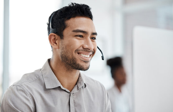 Businessman, call center and smile with headphones in customer service, support or telemarketing at office. Happy asian man consultant agent smiling for online advice, telesales or help at workplace