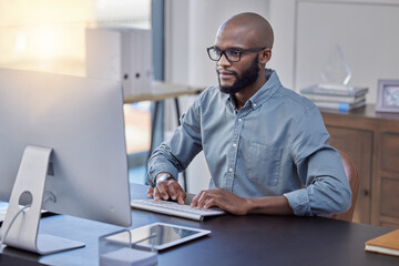 Programmer, computer and black man typing for software, coding or email in office. IT, desktop and African professional working on cyber security, business code or internet research for programming.