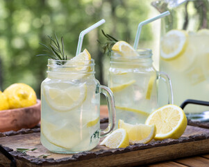 Lemonade in glass jars on table outdoors