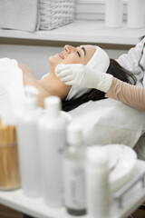 A young woman receives luxurious care from a cosmetologist who cleanses the skin, providing an individual approach and promoting rejuvenation in the beauty salon, relaxing and rest