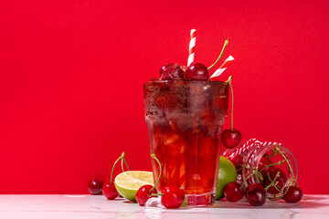 Iced cherry cola drink, Cold summer fruity non-alcohol cocktail with fresh cherries, juice, cola...
