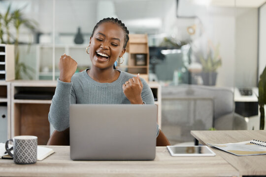 Business woman, laptop and celebration with fist for winning, success or promotion bonus at office. Happy black woman employee in joyful happiness on computer for win, prize or good news at workplace