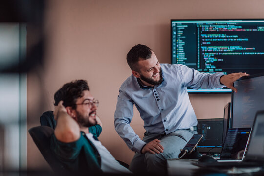 Programmers engrossed in deep collaboration, diligently working together to solve complex problems and develop innovative mobile applications with seamless functionality.