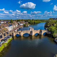 An aerial view along the River Great Ouse towards footbridge in the town of St Ives, Cambridgeshire in summertime