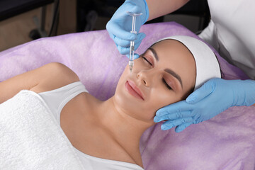 Young woman getting facial injection in beauty salon. Cosmetic procedure