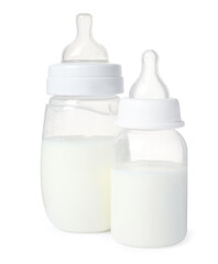 Two feeding bottles with infant formula on white background