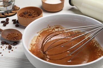 Whipping cream from instant coffee granules and ingredients on white table, closeup