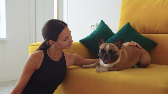 Girl petting, scretching and leaning her dog