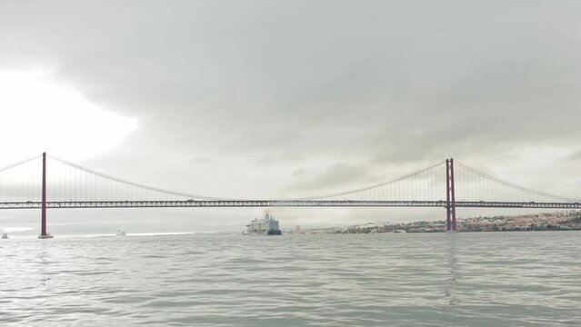 Landscape of a big ship sailing under the bridge