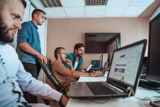 Programmers engrossed in deep collaboration, diligently working together to solve complex problems and develop innovative mobile applications with seamless functionality.