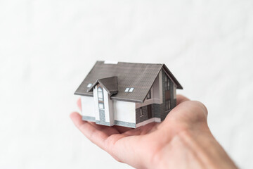 Small toy house in hands