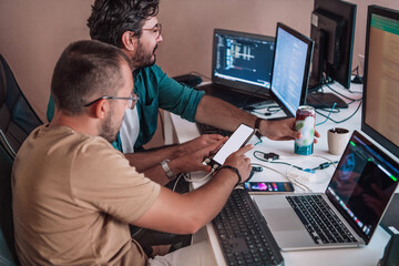 Programmers engrossed in deep collaboration, diligently working together to solve complex problems...