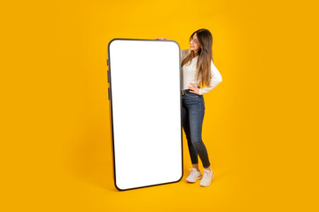 Mobile application offer, cheerful smiling casual young caucasian lady standing near giant big...