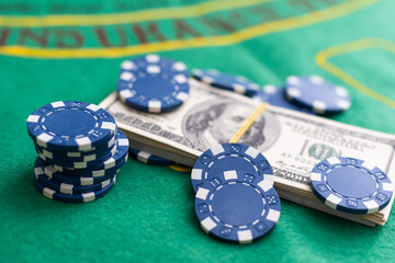 Poker cards royal flush, cash money dollar bills. Gambling, casino chips, dices. Casino tokens, gaming chips, checks, or cheques on green table in casino club.