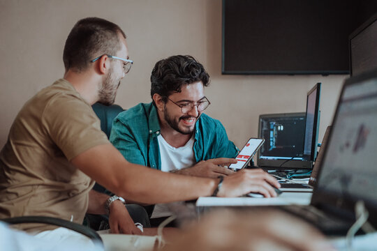 Programmers engrossed in deep collaboration, diligently working together to solve complex problems and develop innovative mobile applications with seamless functionality.