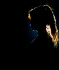 Silhouette of woman's head with ponytail