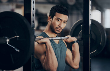 Man, portrait and push press barbell for workout at the gym for strong muscles in a close up. Male athlete, exercise and weight lift for fitness at a club with equipment for healthy body with cardio.