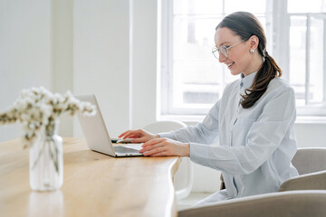 Female programmer student in a blue shirt. My favorite hobby is surfing the Internet. Uses a laptop...