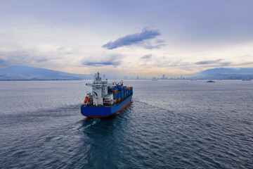 Container Cargo vessel cruising to terminal commercial port. Maritime logistics