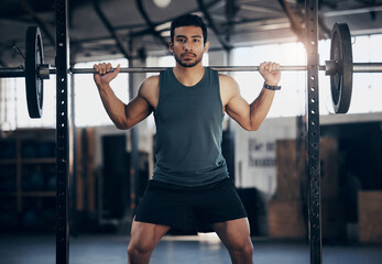 Portrait, exercise and man with barbell in gym for fitness, strong muscle power or health....