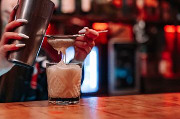 woman hand bartender making cocktail on the bar counter