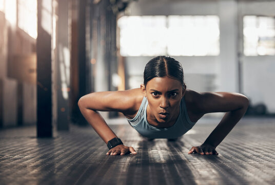 Push ups, workout and portrait of woman in gym for challenge, exercise and performance. Health, strong and sports with female bodybuilder training in fitness center for energy, wellness and focus