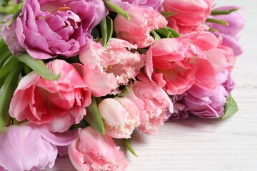 Fototapeta na wymiar Beautiful bouquet of colorful tulip flowers on white table, closeup