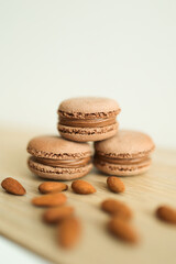 Obraz na płótnie Canvas Chocolate Macaroon with almond on wooden board. Selective focus.