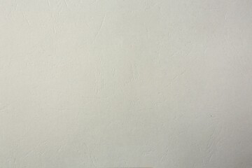 Texture of light grey paper sheet as background, closeup