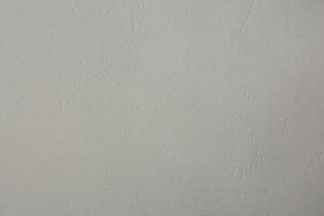 Texture of light grey paper sheet as background, closeup