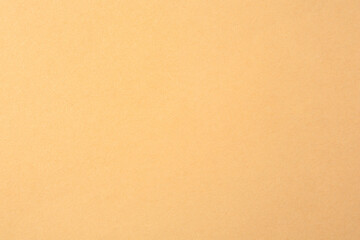 Fototapeta na wymiar Texture of beige paper sheet as background, closeup