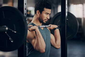 Exercise, workout and man with barbell in gym for fitness, strong muscle power or health....