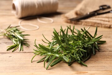 Fresh green rosemary on wooden table, closeup