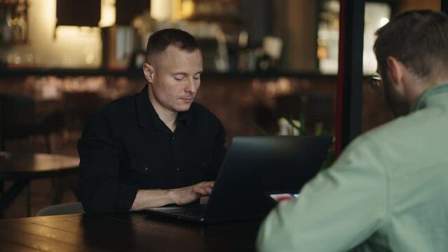 Freelancers Working In Cafe, Men Professionals In IT And Web Design Sitting At Table With Laptops