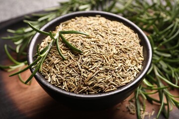 Bowl with dry and fresh rosemary on table, closeup