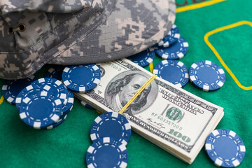 Poker playing chips with card and dollar banknoteson a casino green table. Online gambling. Texas