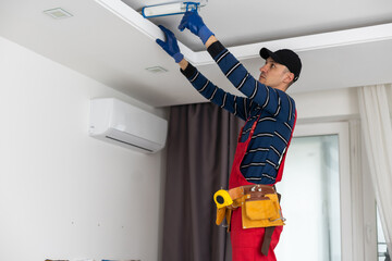 Construction worker installation ceiling work