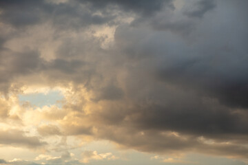 Naklejka na ściany i meble Thunderclouds in the sky at sunset.