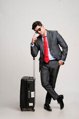 Young indian businessman with a suitcase or trolly. business tour concept