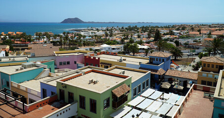 Fototapeta premium View over roof tops at Corralejo Fuerteventura looking toward Lobos Island