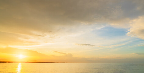 Sunset sky clouds over sea in the evening with yellow, orange sunlight on Golden Sky hour, Horizon sea landscape background on summer 