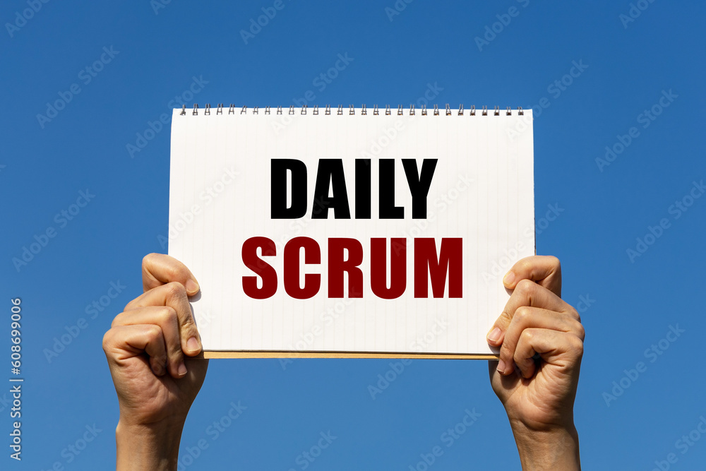 Poster daily scrum text on notebook paper held by 2 hands with isolated blue sky background. this message c