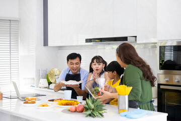 Happy family cooking together on kitchen. happy smiling parents enjoy weekend