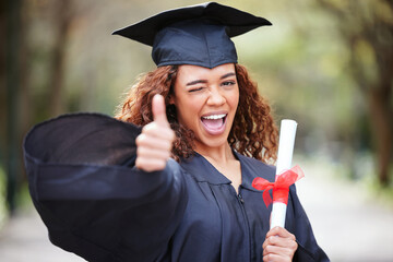 Thank you, portrait of college student with thumbs up and winking for success at her campus outdoors. Achievement, graduate and female person with her certificate or diploma at university outside