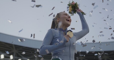 Young Female Athlete Celebrates a Win on a podium, receives a gold medal