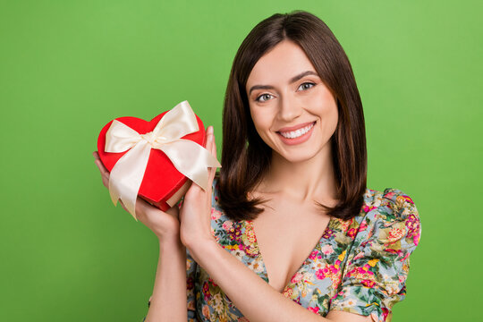 Photo portrait of young charming girl brown hair receive gift box surprise from her valentine boyfriend isolated on green color background