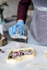 Epoxy Resin Art. Creating Art with Resin on workshop. The art process of creating epoxy resin...