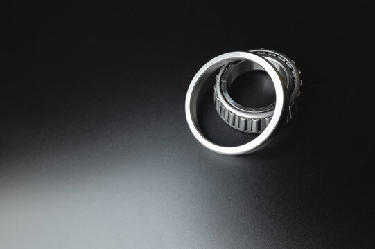 Two-piece tapered bearing. New spare part on a black background