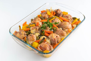 In a glass dish, baked chicken pieces with beans and carrots. The concept of proper nutrition.